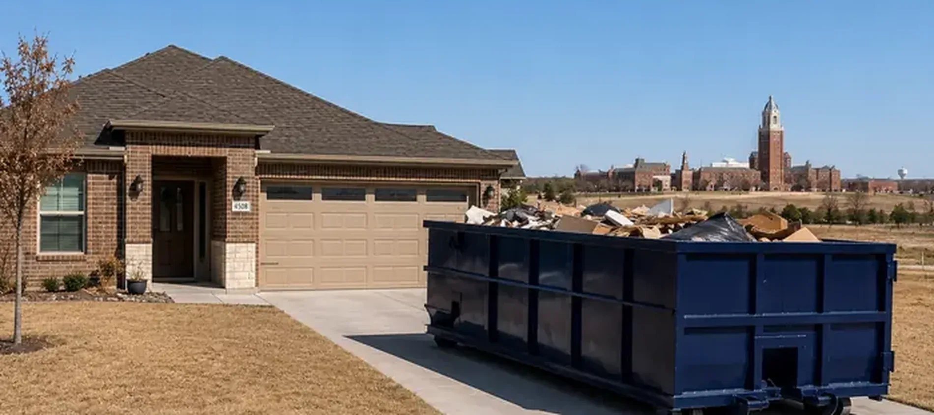A roll-off dumpster delivered to a residential driveway in Canyon, TX.