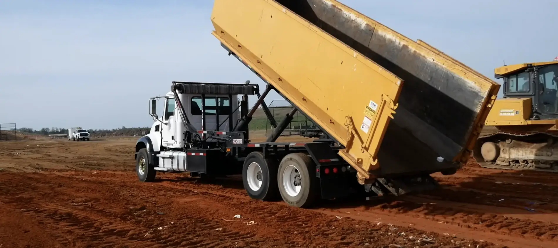 An empty roll-off dumpster being emptied at the landfill, where the load is weighed before billing.