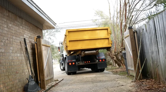 A delivery truck navigating a tight gated access lane in Timbercreek Canyon.